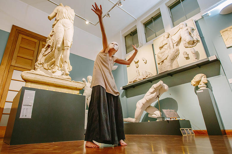 Masked performer dancing in the Cast Gallery