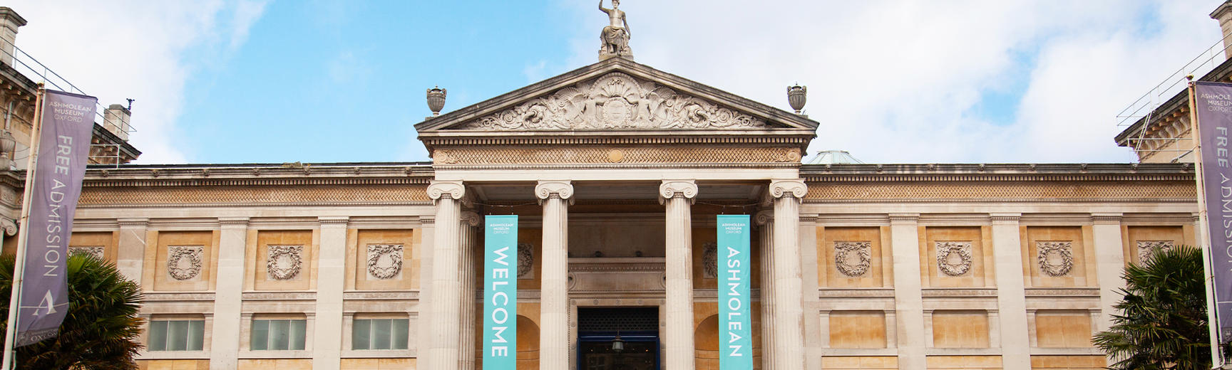 The front of the Museum against a blue and cloudy sky