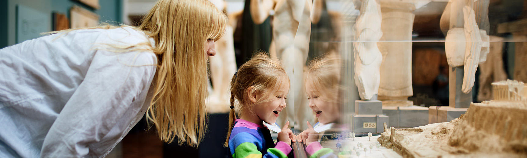 Mother and child looking at a display case in the galleries